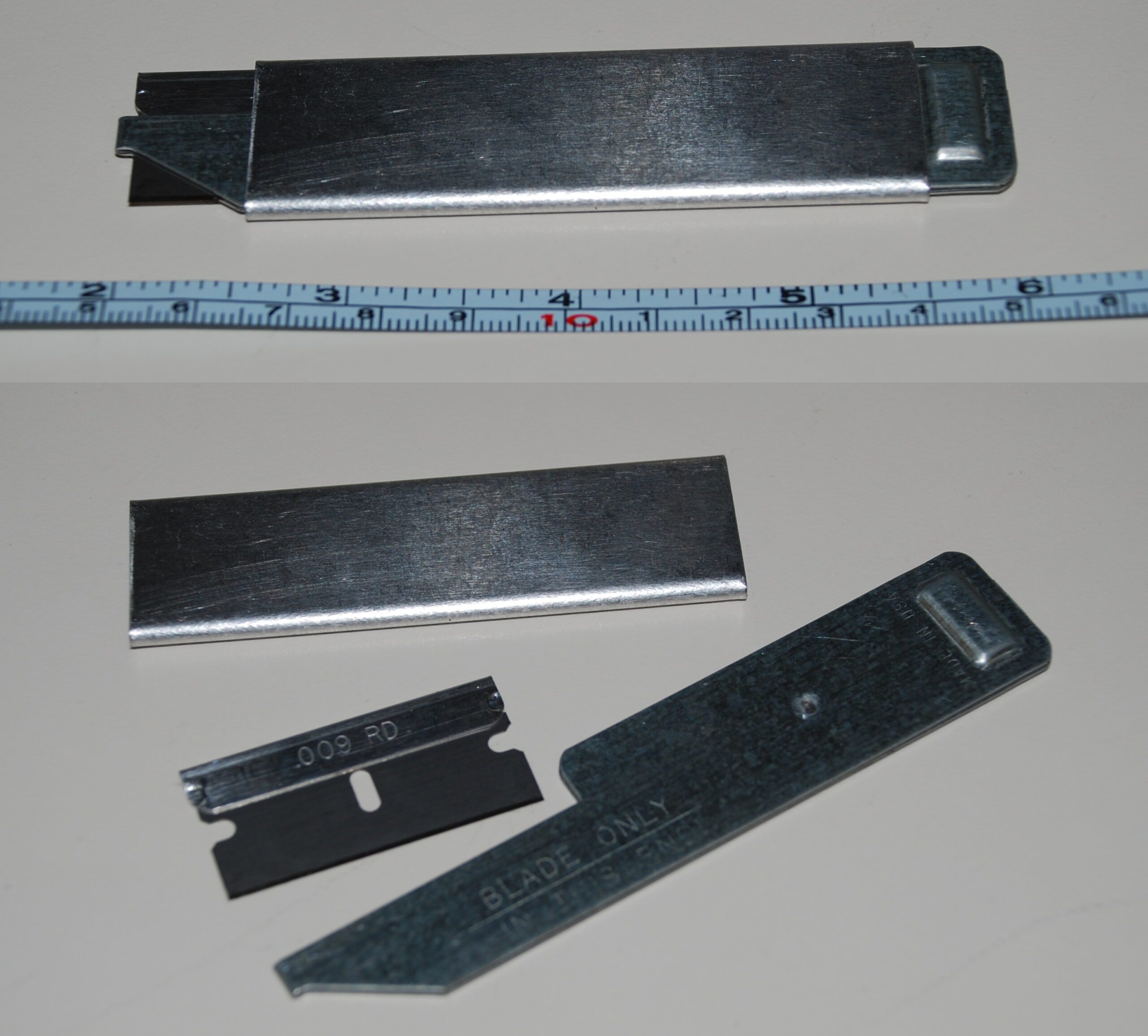 Box cutter utility knife used for cutting security window film with straight edge on self-healing cutting mat
