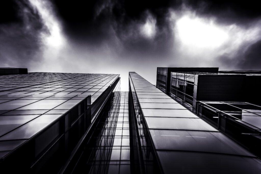 Low-angle view of a dark glass curtain wall facade on a commercial office building