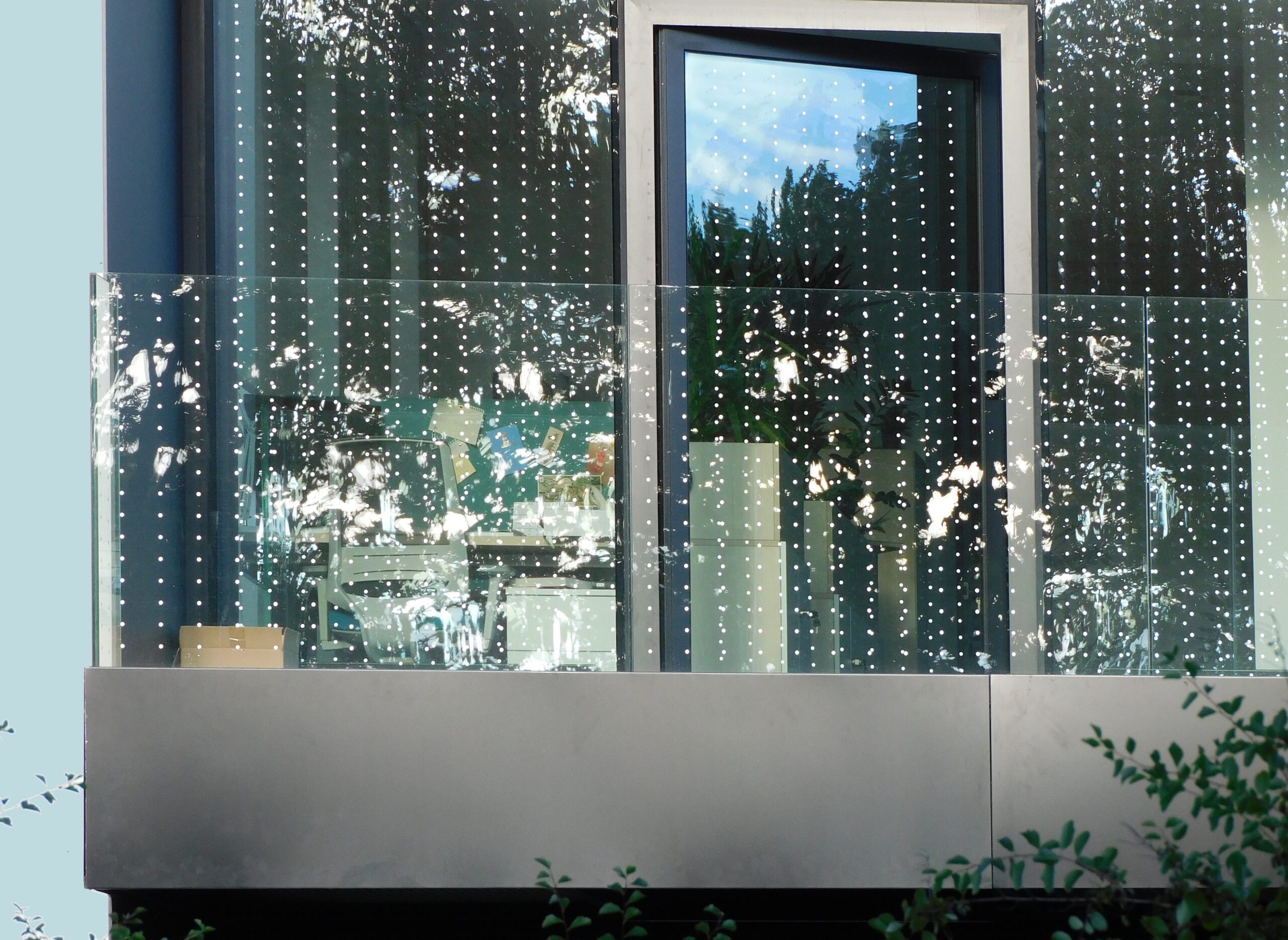 Dotted glass bird collision deterrent film applied to a building exterior window in Vancouver BC