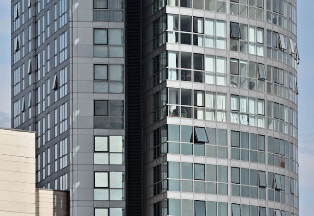 Solar control window film installed on a glass office building facade, reducing solar heat gain
