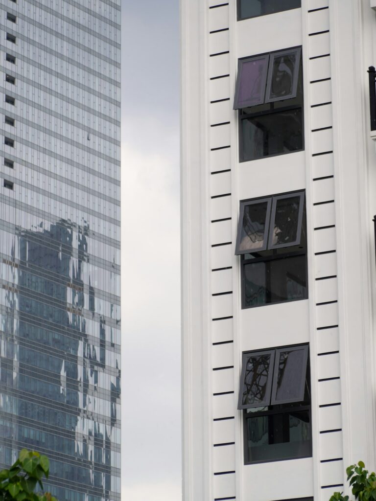 Modern commercial building with reflective one way window film showing mirror effect on exterior glass