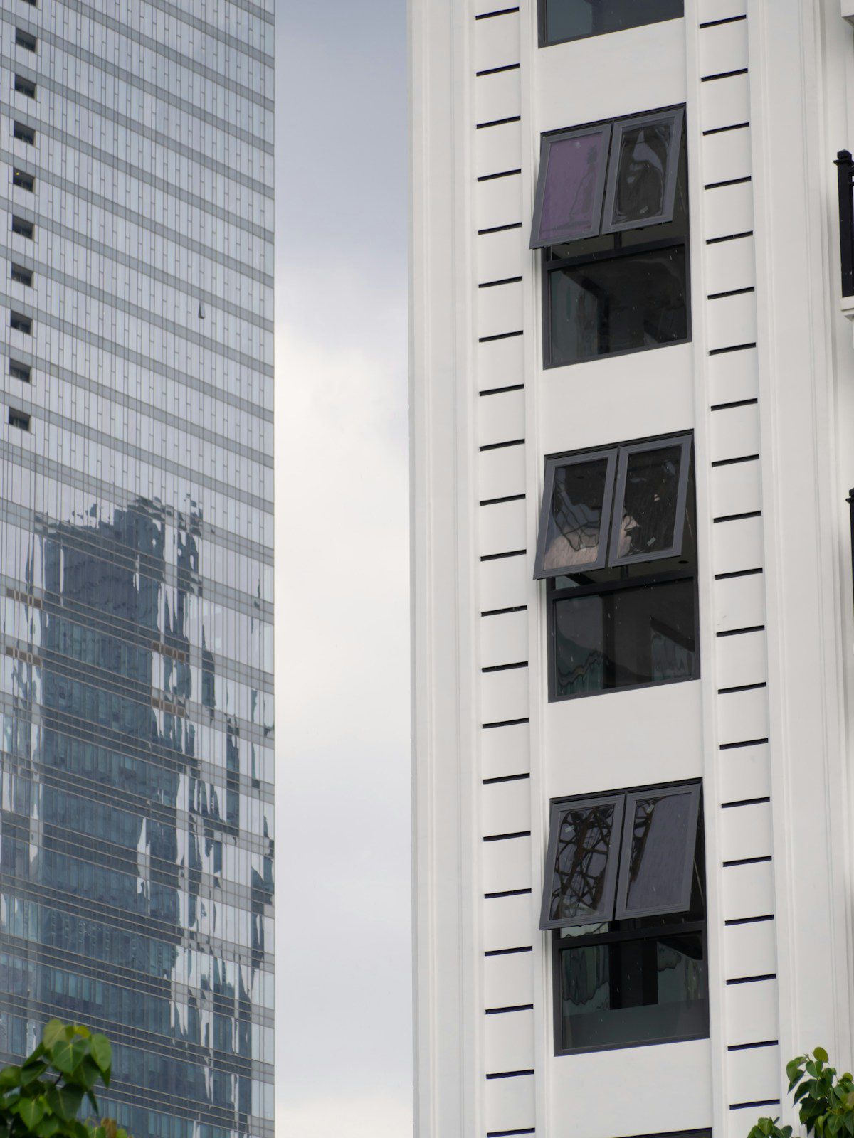 Modern commercial building with reflective one way window film showing mirror effect on exterior glass
