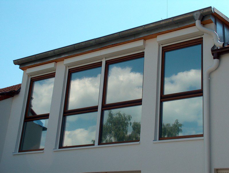 Chrome solar window film installed on a residential house — solar protection film for homes