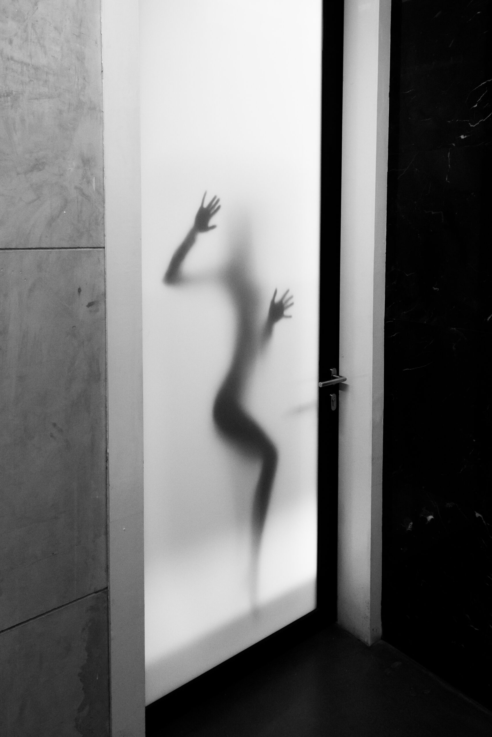 Woman's silhouette behind frosted glass — illustrating privacy window film for bathroom windows in BC