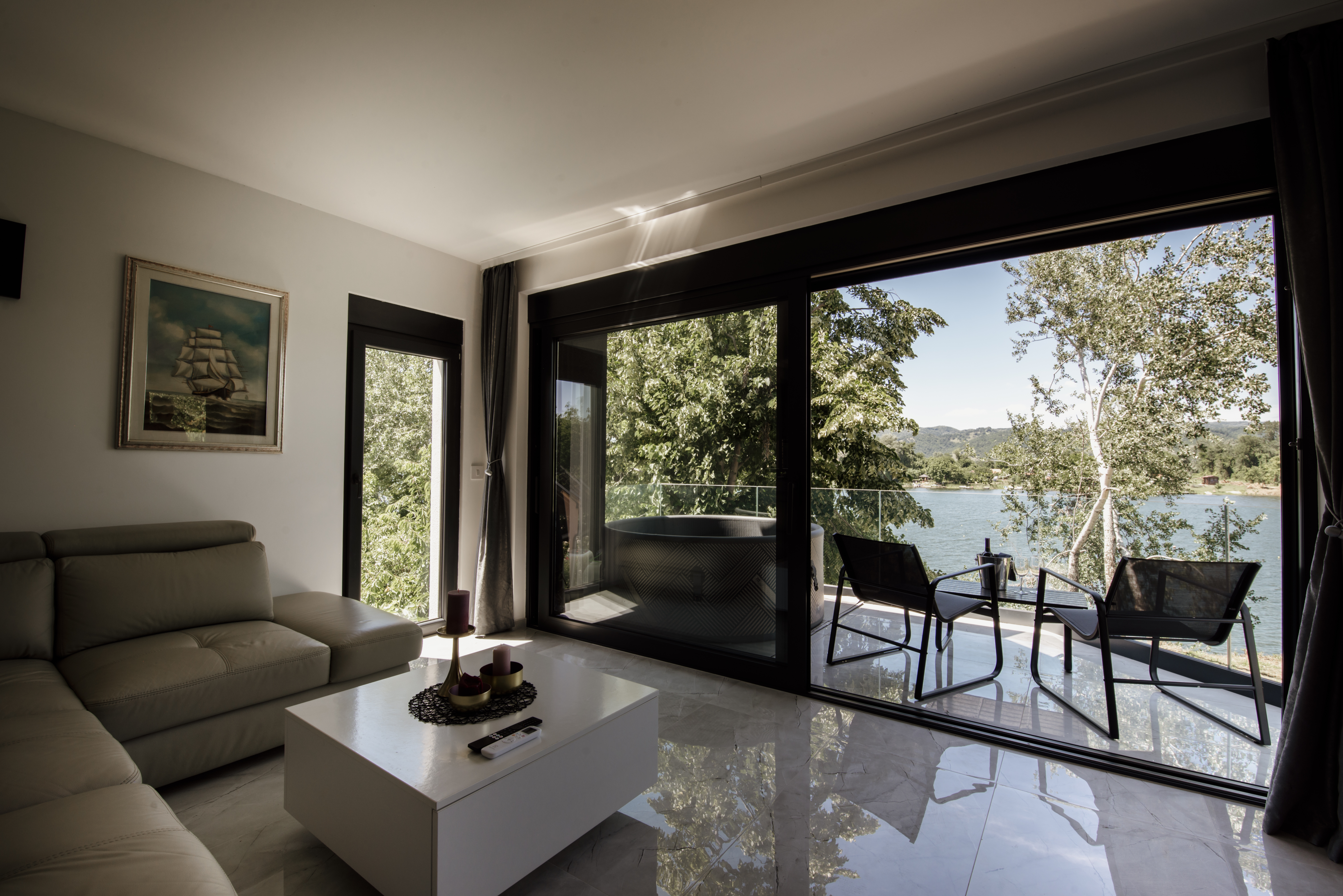 Sunlit living room with large windows, the kind of exposure that fades furniture without UV film