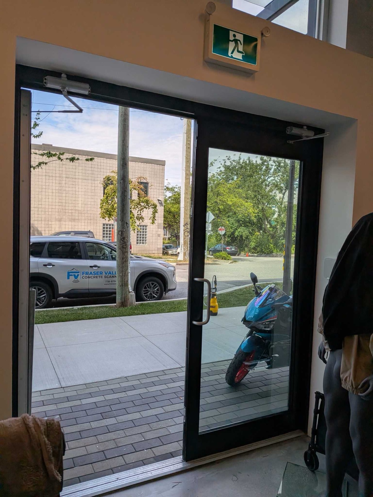 Close-up of clear security window film being squeegeed onto commercial glass
