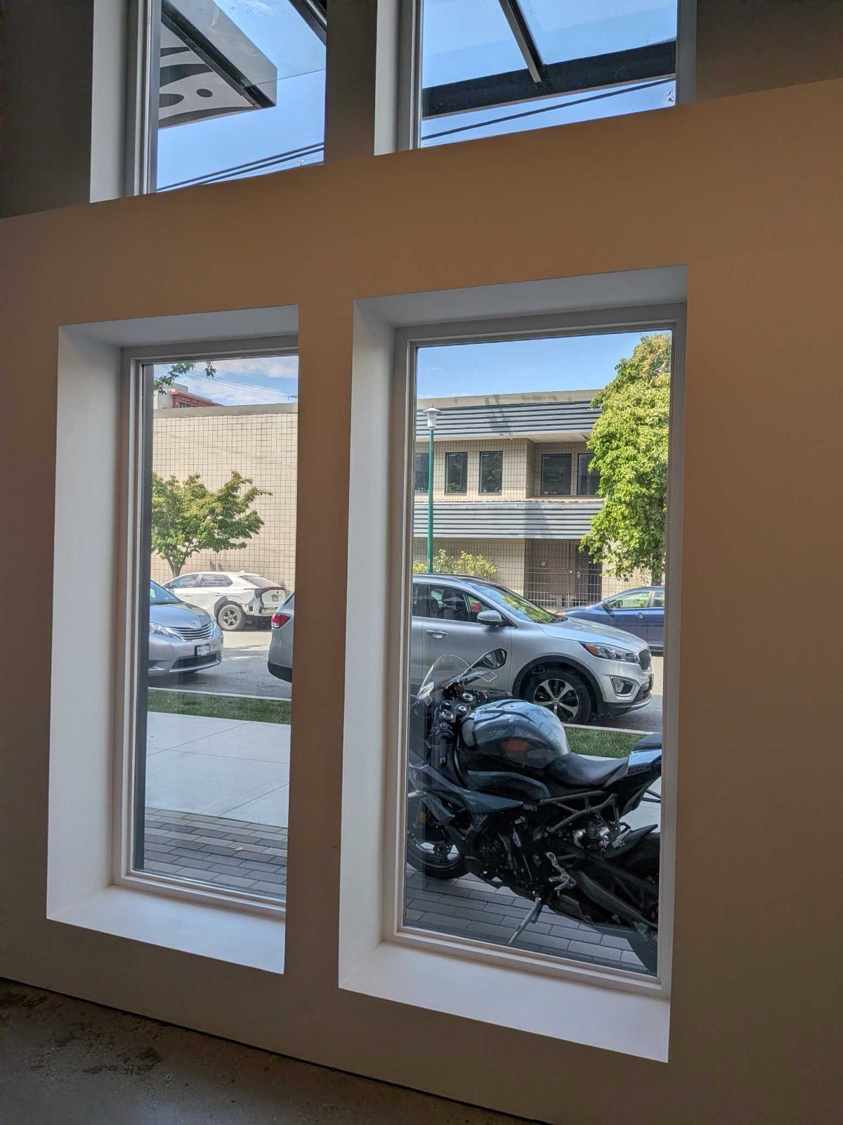 Tall storefront windows at the Motohut security-film project