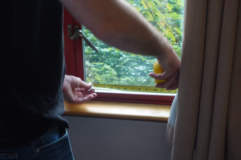Ecovision technician measuring a window at St. Michaels Extended Care