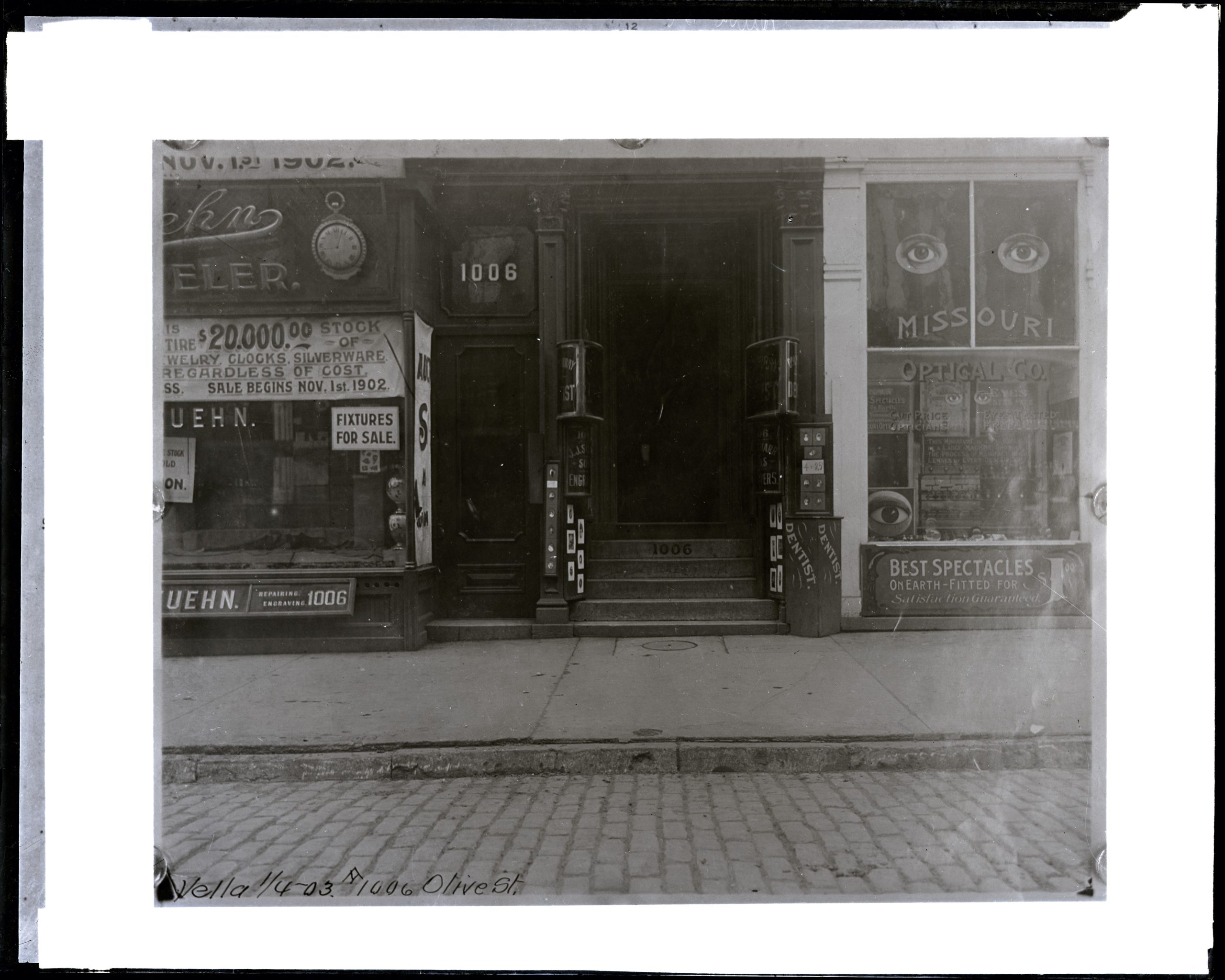 Historic commercial storefronts including a dentist office with large street-facing glass